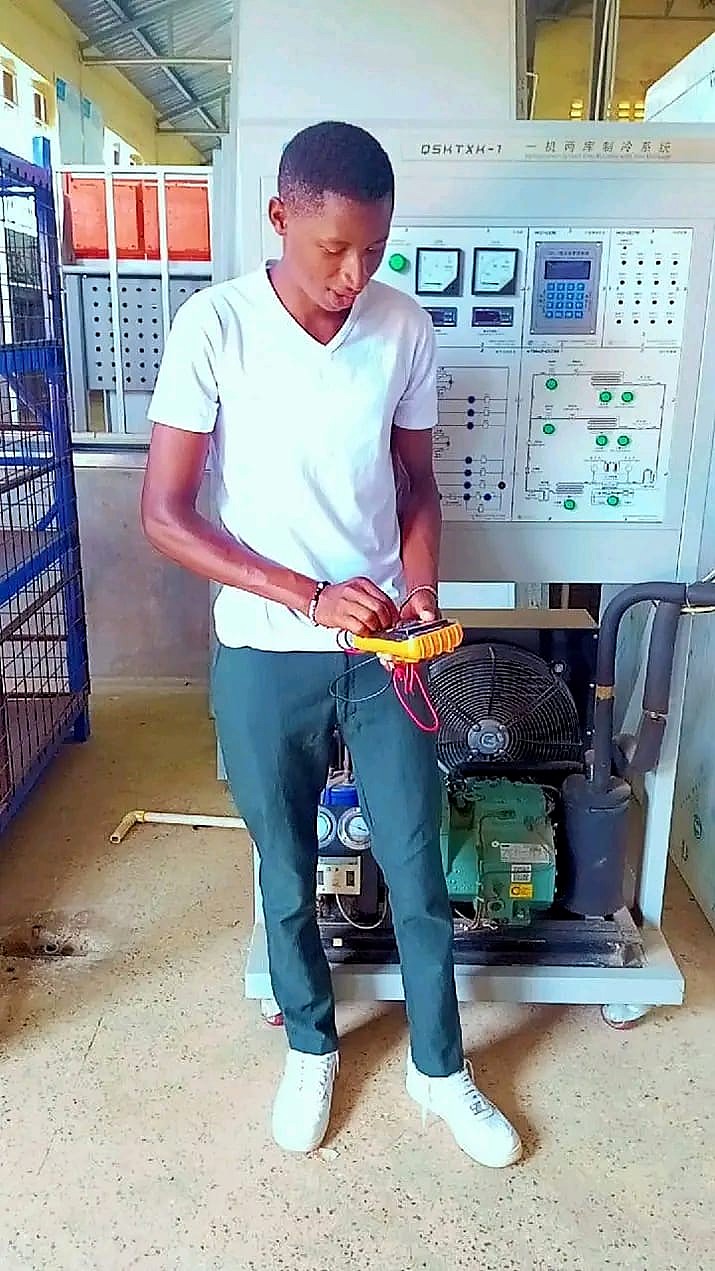 Technician testing refrigeration equipment